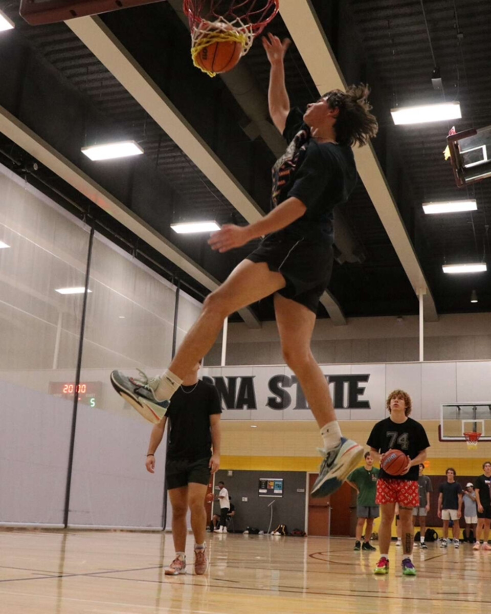 Evan jumping toward the hoop on a basketball court