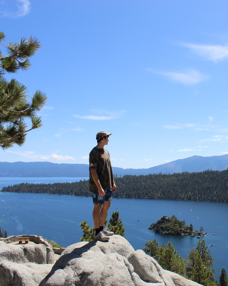 Evan standing on a rock overlooking Lake Tahoe